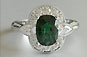 cushion cut emerald center stone cluster, white gold custom design ring, pear cut diamond sidestones