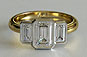 Yellow Gold Emerald Cut Three Stone Bezel Set Engagement Ring