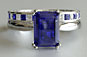 Emerald Cut Sapphire Solitaire Engagement Ring with Princess Cut Diamond Band