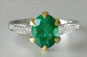 oval emerald, two-tone ring, shoulder diamonds